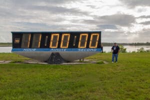 Standing in front of the iconic countdown clock which is stopped at -11:00:00