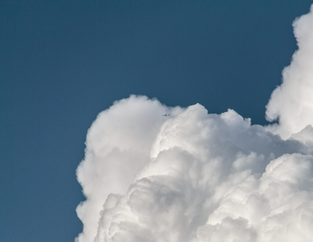 A plane flies around the developing storm