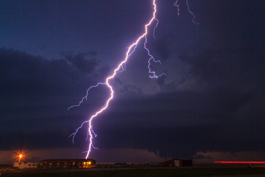 Lightning striking behind a house