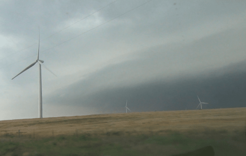 Lots of energy coming out of the El Reno supercell. Video capture from the south looking across wind farm near Union City