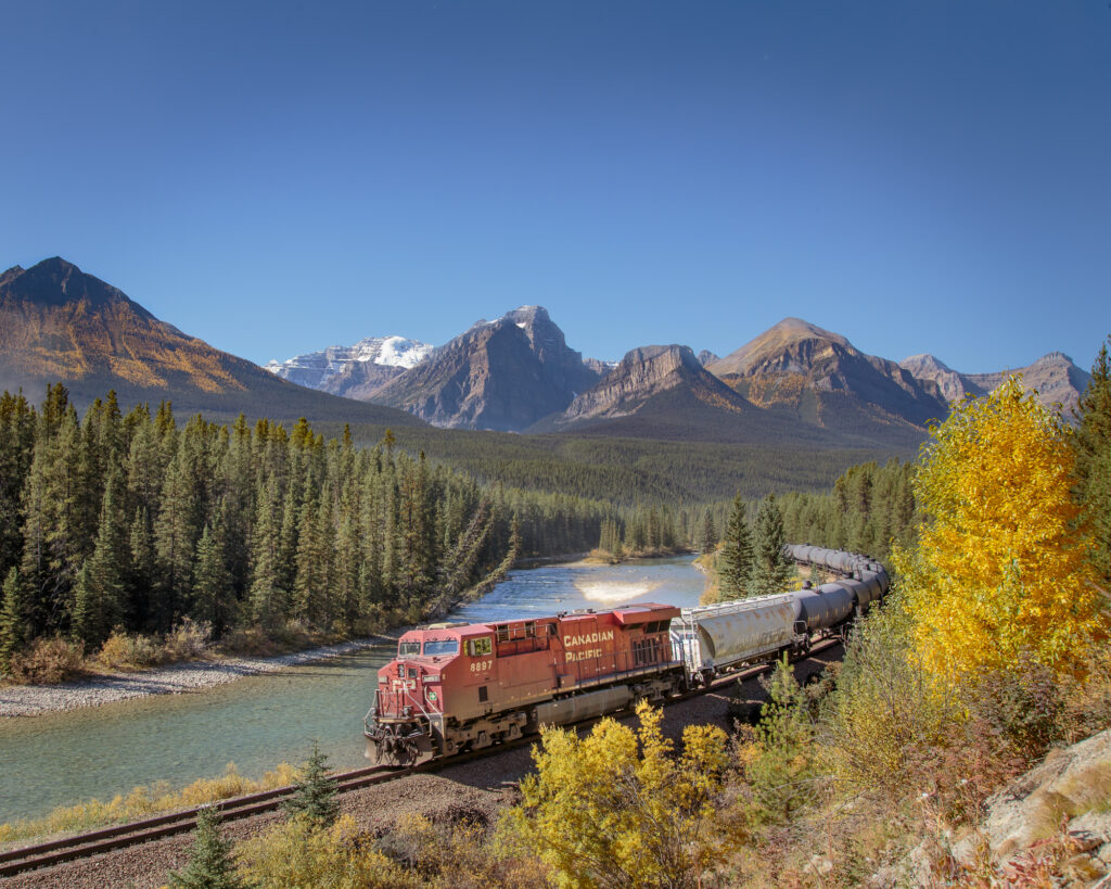 A Canadian Pacific Train travels through Morants Curve in Banff National Park on a sunny day in September 2017