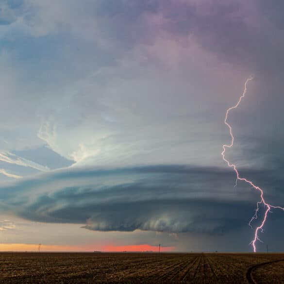 A bolt of lightning strikes ahead of a beautifully sculpted mesocyclone on a storm near Sublette, Kansas on May 21, 2020