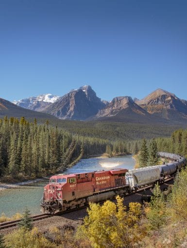 A Canadian Pacific Train travels through Morants Curve in Banff National Park on a sunny day in September 2017