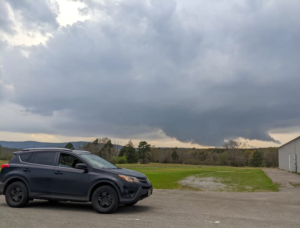 Storm Chaser Pecos Hank views a storm from a parking lot in Talihina, Oklahoma