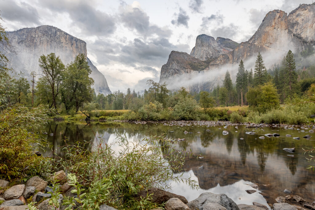 A dramatic scene in the Yosemite Valley as rain showers leave fog