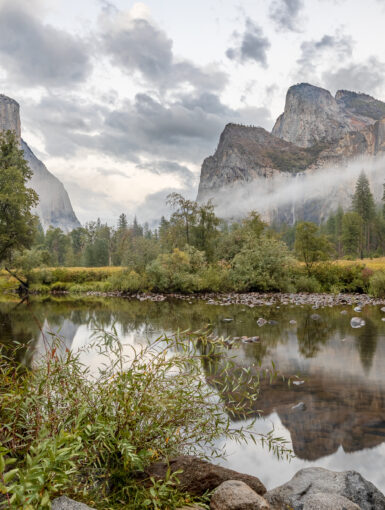A dramatic scene in the Yosemite Valley as rain showers leave fog