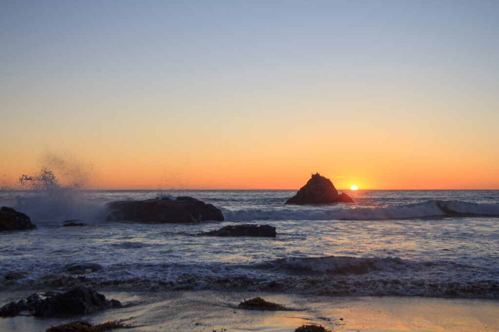 Waves crash into the rocks along the pacific coast near San Simeon, CA