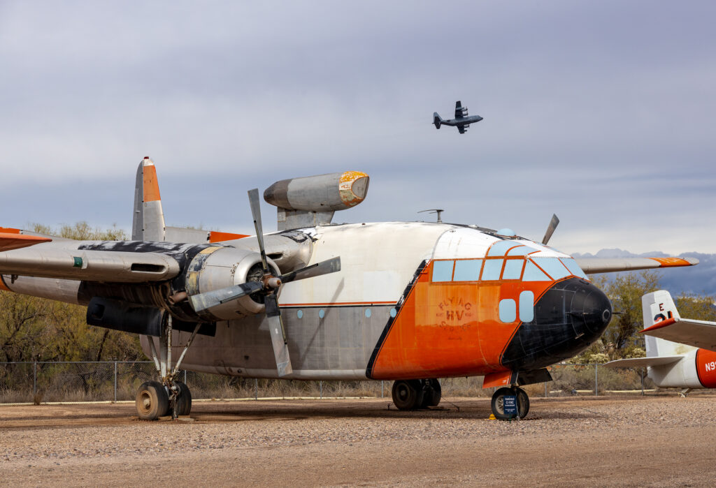 Flying Boxcar with a C-130 flying in the back ground
